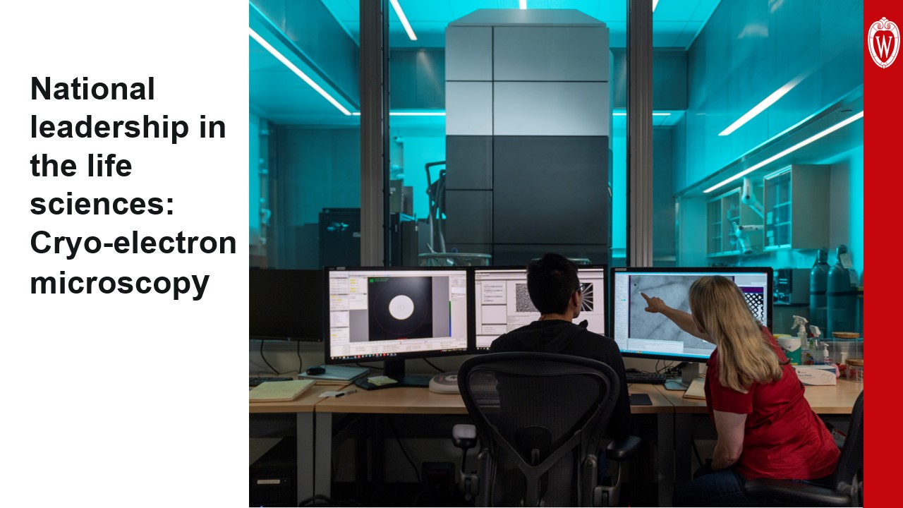 This slide is titled “National leadership in the life sciences: Cryo-electron microscopy” and includes a photo shot from behind of a faculty member meeting with a graduate student in front of a large microscope tower.