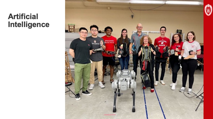 Slide 30: The words “Artificial Intelligence” appear on the left. On the right is a photo of Chancellor Mnookin standing with students in a robotics lab. In front of them is a four-legged robot.