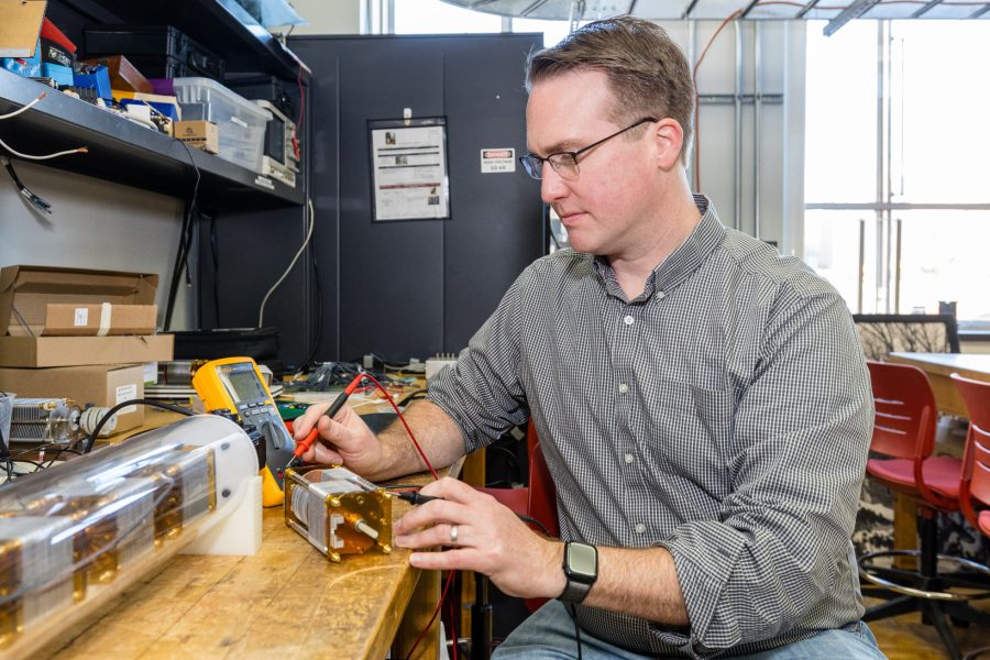 Dan Ludois, a professor of electrical and computer engineering in the College of Engineering, works in his lab