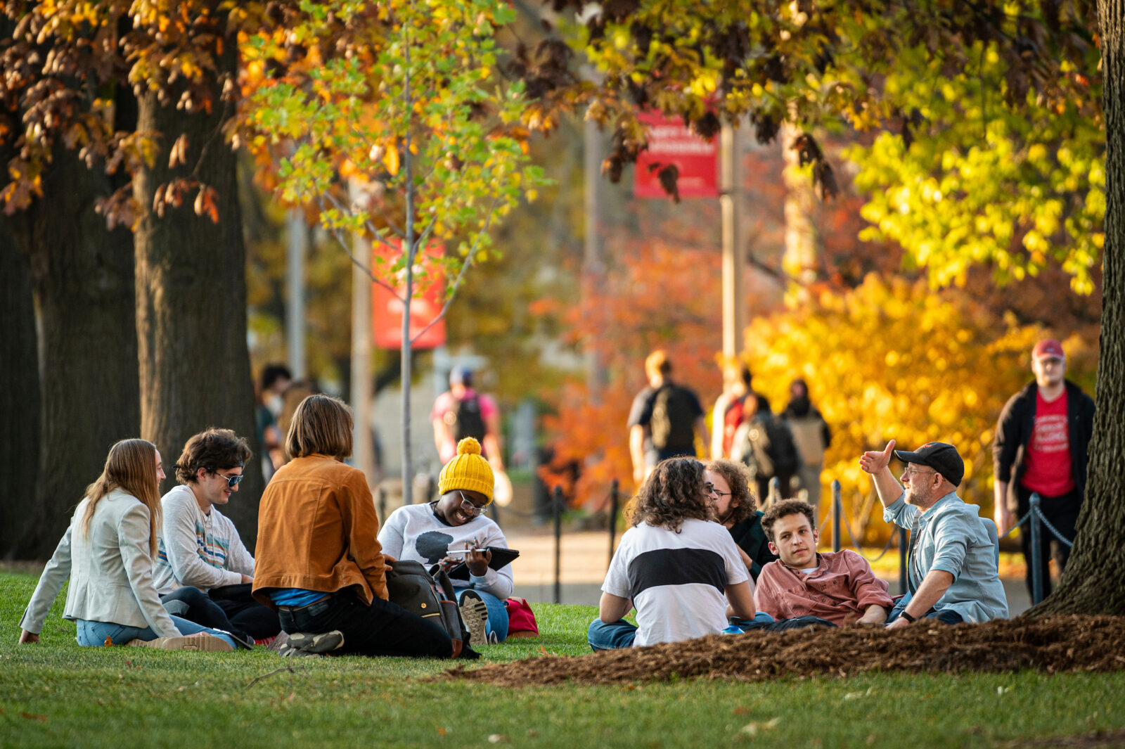 Students sit in circle during a class discussion outdoors on Bascom Hill.